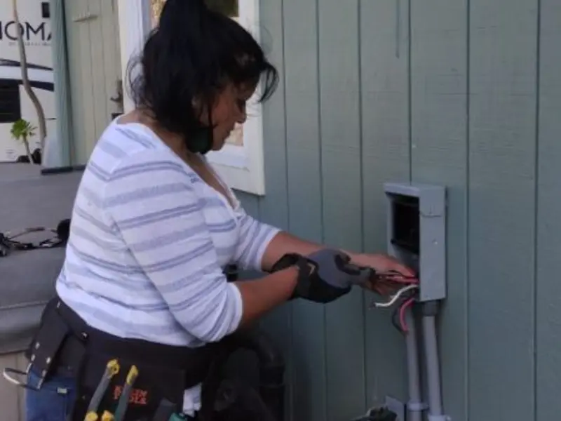 Licensed electrician wiring an exterior subpanel in Warrior