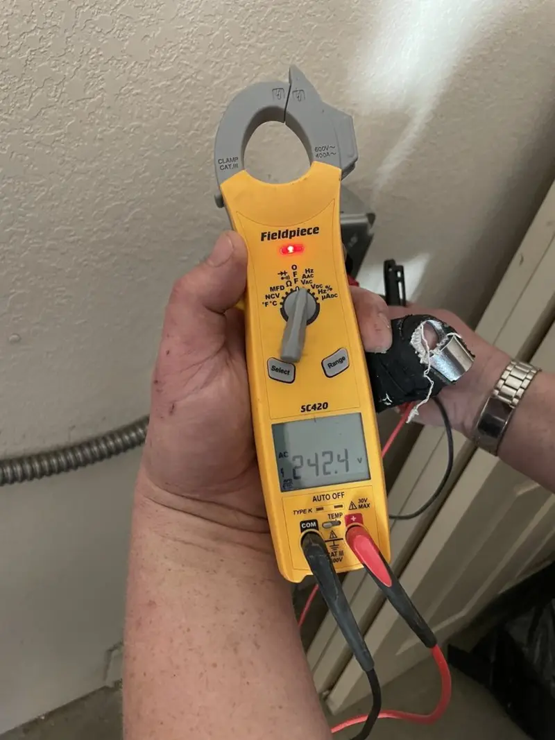 Voltage testing with clamp meter during Whole House Surge Protector in Warrior
